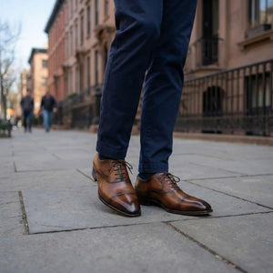 Man walking on street in brown dress shoes