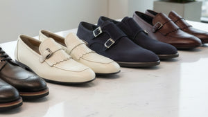 Line of mens dress shoes on a table