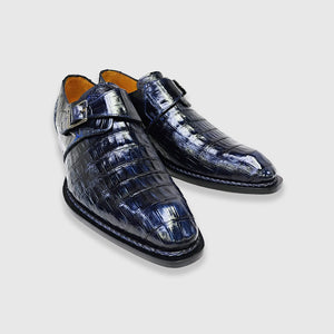 Pair of blue exotic shoes on a light gray background