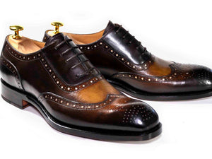 Pair of brown leather dress shoes on a white background